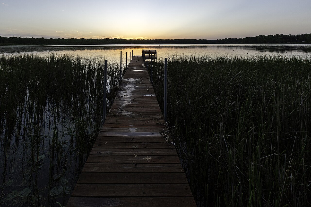 Dock and cattails beside Big Sandy Lake near McGregor at sunset