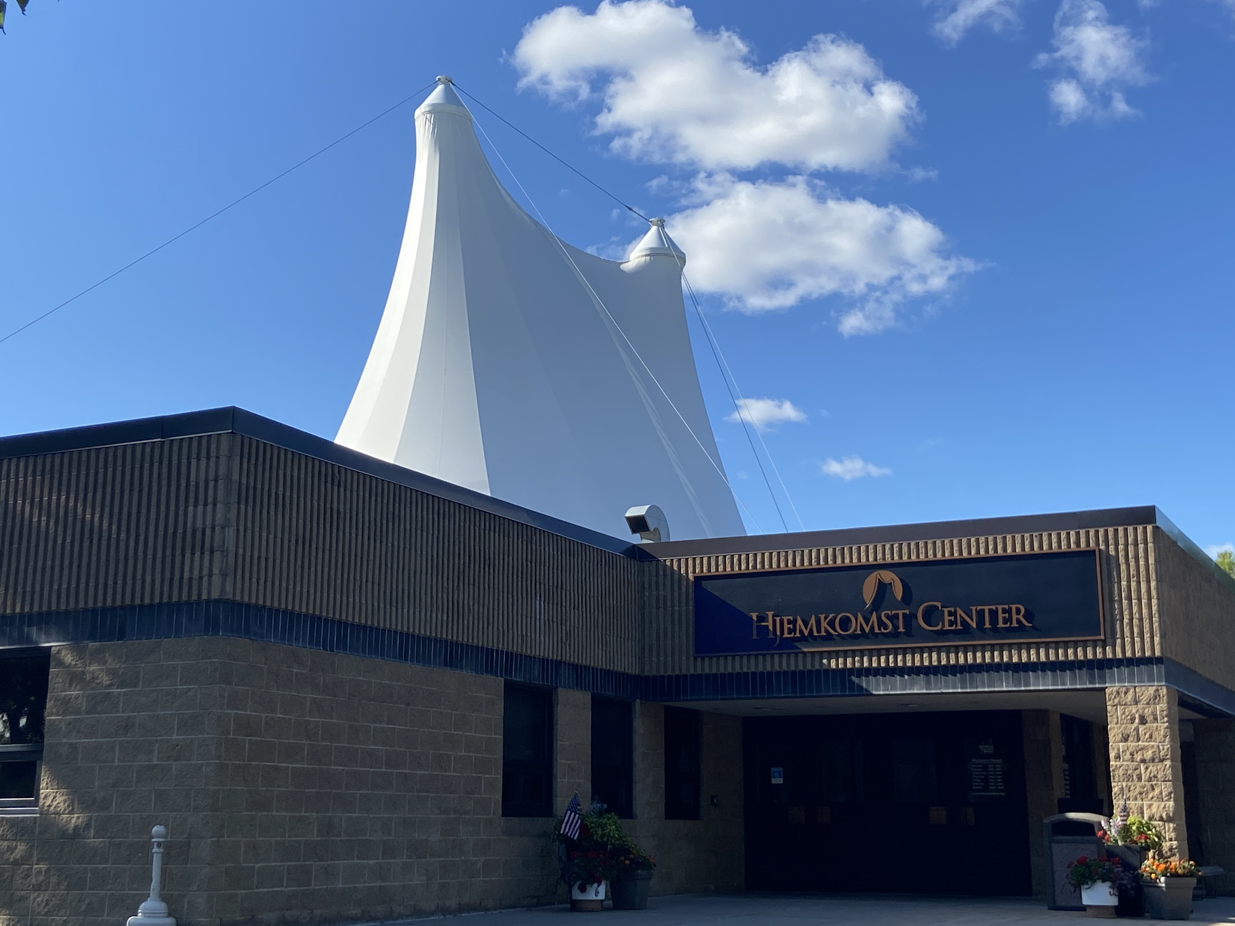 White tent-like roof rising above the Hjemkomst Center entrance in Moorhead