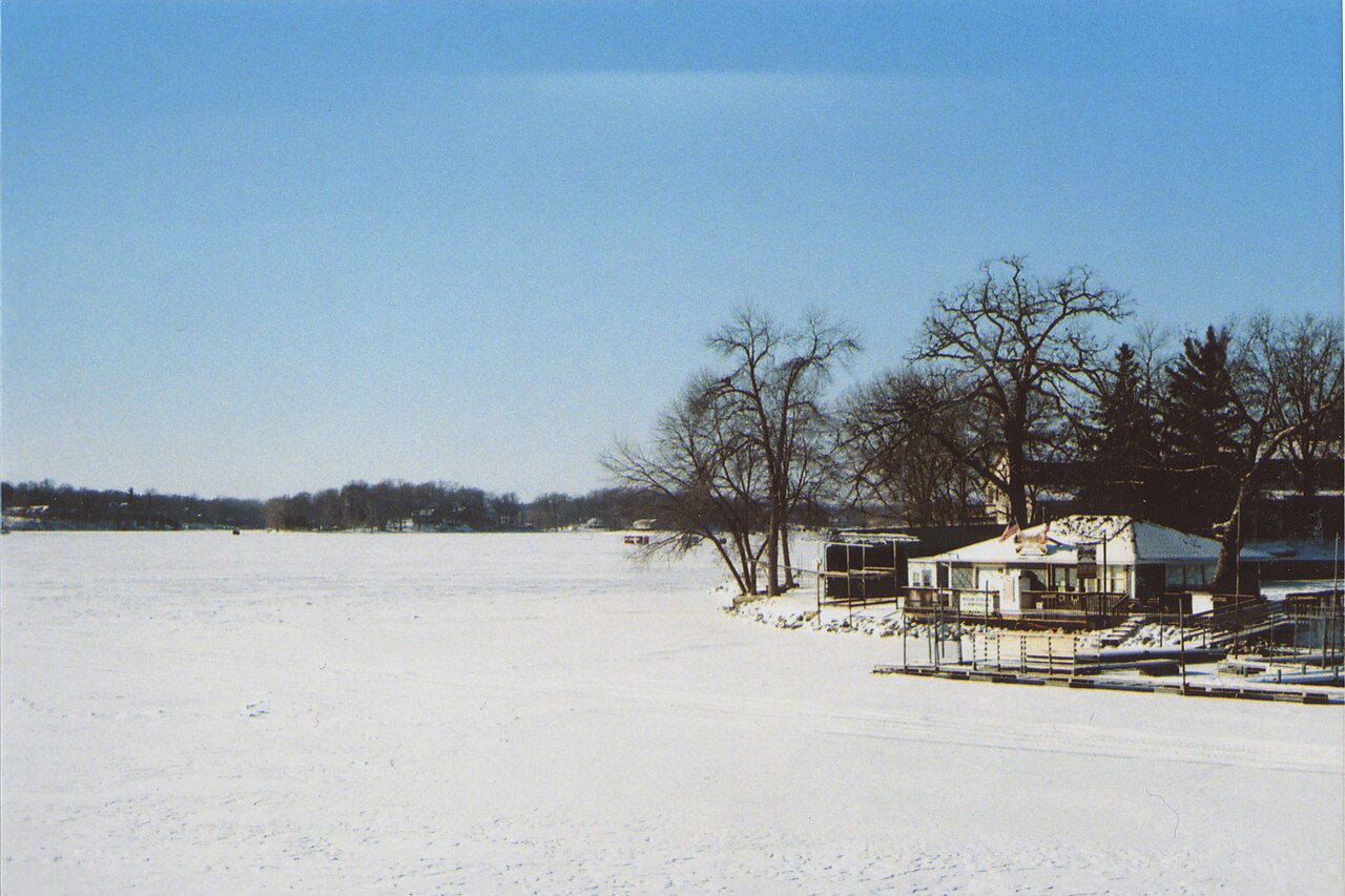 Snow-covered Prior Lake and shoreline buildings viewed from the bridge
