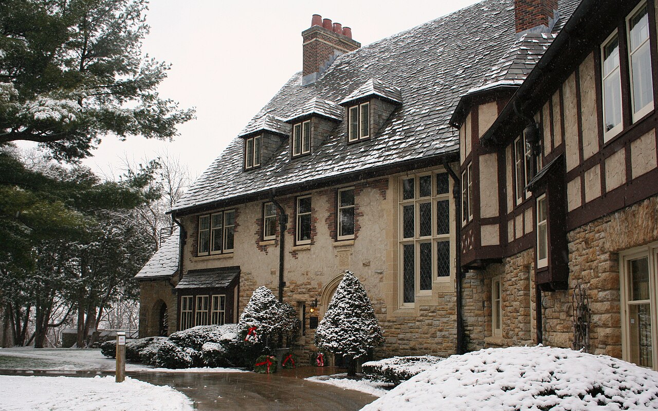 Snow on the stone and timber exterior of Plummer House in Rochester