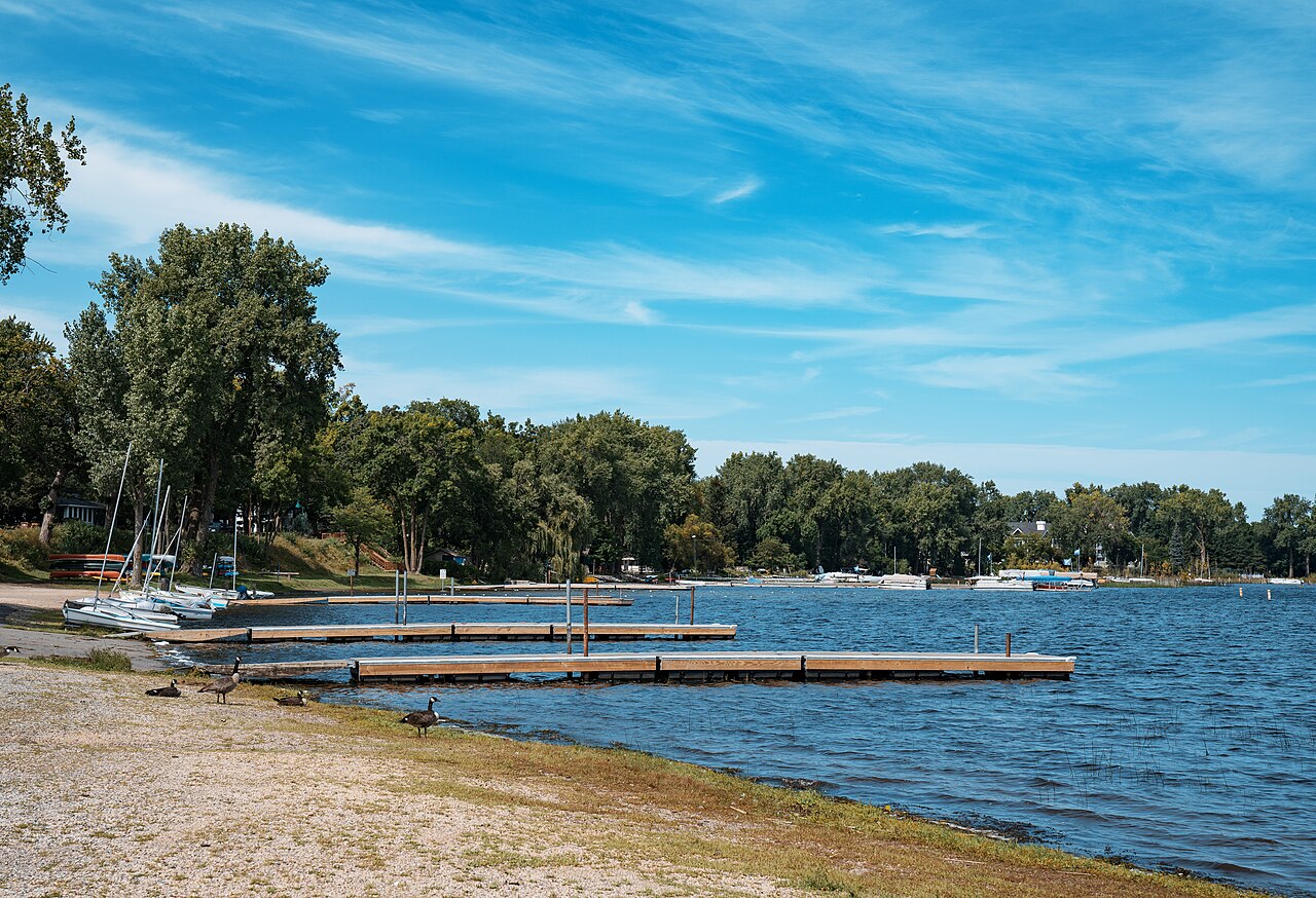 Docks and small sailboats beside the shoreline at Matoska Park on White Bear Lake